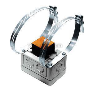 Grey box with an orange circular cap sits against a pipe; two metal bands wrap around the pipe to hold it in place.