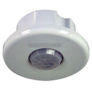 Round white ceiling motion sensor with domed translucent lens for detecting occupancy.