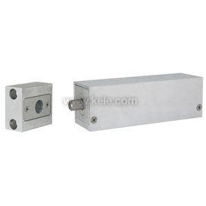 A rectangular metal housing with a protruding cylindrical latch, accompanied by a smaller square piece that acts as the keeper.