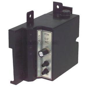 Rectangular black box with a front panel featuring a small knob and dials used to adjust pressure settings.