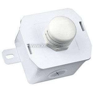 Small white box with a large round button-like component on top and a metal tab on the side for mounting.
