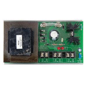 Green circuit board with transformer, capacitor and screw terminals.