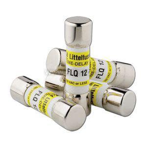 Five small cylindrical fuses with shiny metal ends and yellow paper labels; they are arranged in a loose pile.