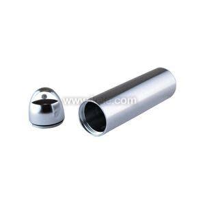 Shiny metal tube and separate rounded cap lying beside it.