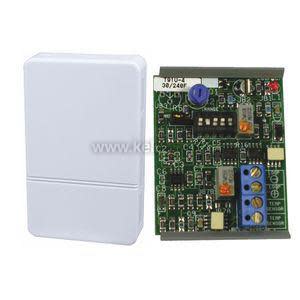 White rectangular sensor housing alongside its circuit board containing multiple electronic components and small blue connector blocks.