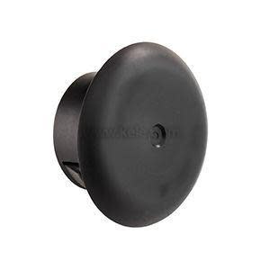 A circular black plug with a domed surface and tiny center depression, designed to fill holes.