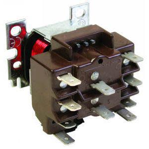 Rectangular brown block with rows of metal prongs; a red coil is visible inside the clear front.