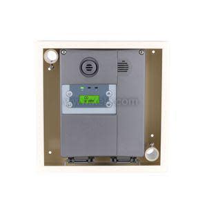 Beige wall box containing a grey CO sensor with a vent and small digital screen.