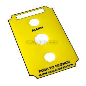 Yellow rectangular panel with two circular holes and printed words 'Alarm' and 'Push to Silence'