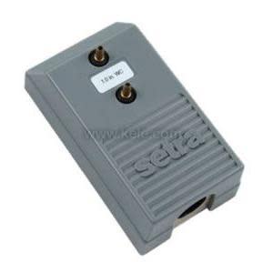 Grey rectangular sensor with ribbed front and two brass ports.