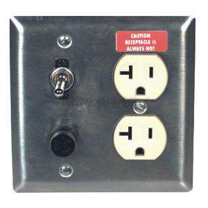 Stainless plate with two receptacles, toggle switch and yellow caution label.