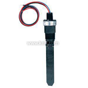 Brass tee-fitting with black housing on top and stainless paddle protruding into flow path