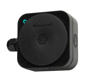 Black square housing with large round circular front featuring a honeycomb vent and small green LED indicator on top corner