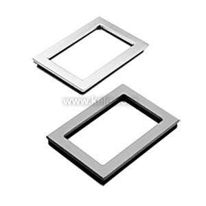 Two small metallic frames that act as trim for a small cutout.