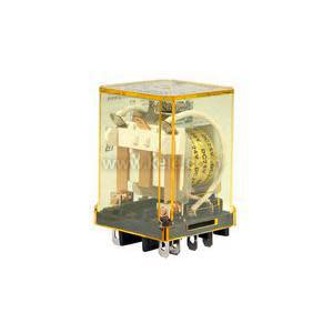 A small clear plastic cube housing an electromechanical relay; internal coil and metal contacts are visible through the yellow‑tinted casing