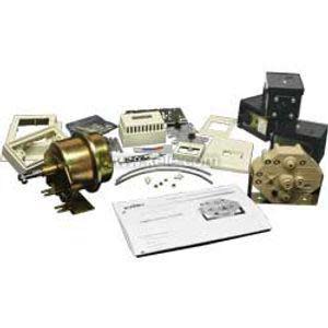 A collection of miscellaneous industrial parts, including brass diaphragm assembly, electronic modules, terminal blocks, wiring accessories, and an instruction booklet, laid out together.
