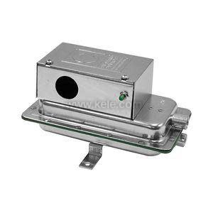 Rectangular silver metal box with round opening and green set screw mounted on larger flat housing with mounting bracket