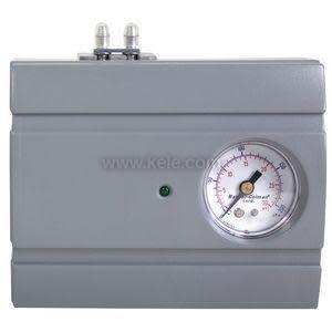 Gray rectangular pneumatic controller with analog gauge and two ports on top.