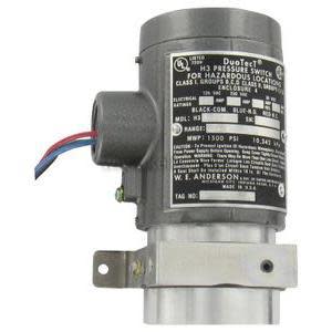 Industrial pressure switch with grey body and black label.