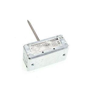 A small metal box with a thin metal rod protruding and a label on the top surface.