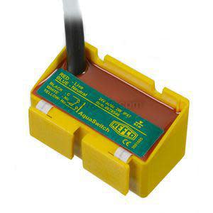 Small yellow rectangular condensate switch with printed label and black cable exiting top