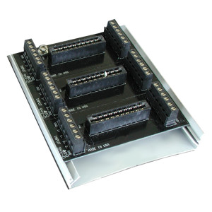 photo of a rectangular circuit board with multiple black plug-in connectors arranged in rows, set on a metal mounting plate; marked 'Made in USA'