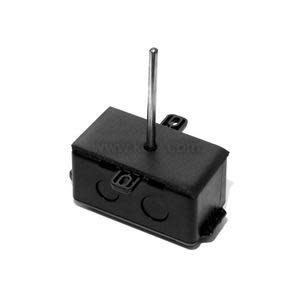 Dark rectangular box with a metal rod sticking up and several round indentations for wiring connectors.