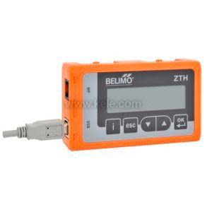 Small orange handheld device with two-line LCD screen and integral cable.