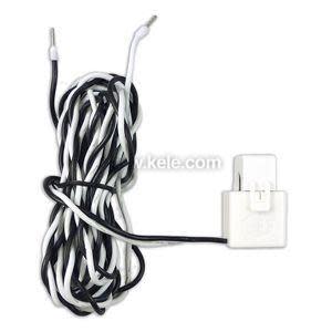 White sensor block with long twisted black and white leads.