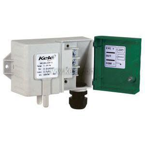 Small grey rectangular device with a green lid open to show three screw terminals; two white tubes stick out of the bottom and there is a black knob.