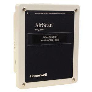 Rectangular gas sensor with beige plastic body and dark navy front label reading AirScan; four screws are visible in the corners.