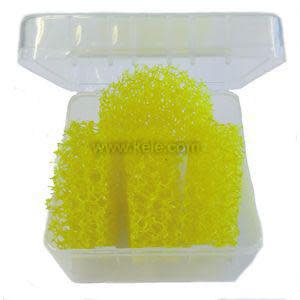 A small clear hinged plastic box containing a bright yellow sponge-like porous material used for humidity sampling or filtration