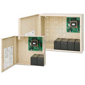 Open beige electrical enclosures showing a green printed circuit board mounted inside and several rectangular black battery modules along the bottom