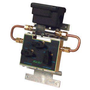 Valve assembly with copper U-shaped tubes, a black solenoid coil on top and a green control panel