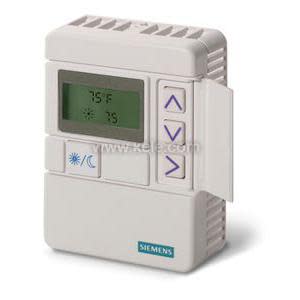 Off-white rectangular thermostat with LCD showing temperature and vertical arrow buttons on right.