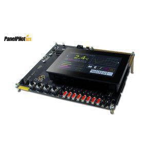 An electronic development board with a small touchscreen and a row of red connectors along one edge.