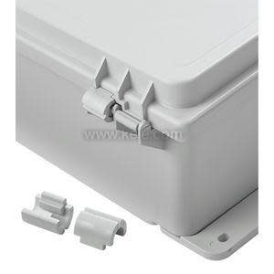 A detailed view of the corner of a gray plastic weatherproof box showing its hinge and latch system, with two small matching clip parts placed next to it, set against a white background.