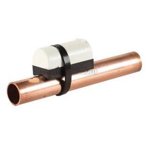Small white and black sensor strapped onto a copper pipe for measuring temperature