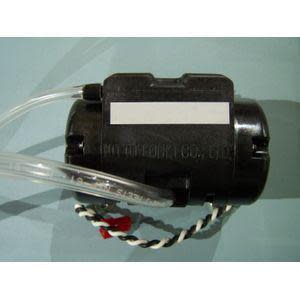Black plastic pump with attached clear tubing and colored wire leads.