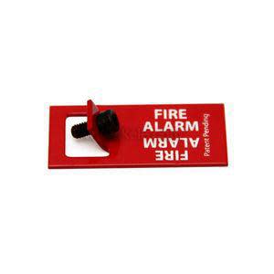 Small red plate labeled fire alarm with black screw and white lettering