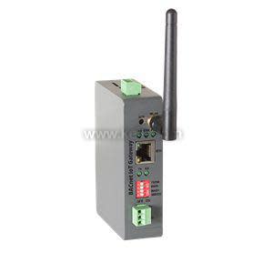 Compact grey industrial IoT gateway with a vertical black antenna, Ethernet port, LED indicators and green terminal blocks