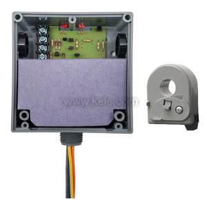 Grey electrical enclosure containing a circuit board and purple insulating pad, with a separate grey clamp-on current sensor and colored wires