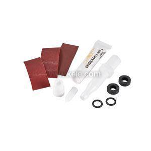 Collection of small maintenance items including a tube of lubricant, red rectangular abrasive pads, circular black rubber gaskets and white plastic nozzles