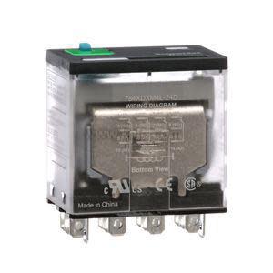 A clear rectangular relay module with a visible metal coil, a green manual test button on top, and an array of metal spade connectors at the base