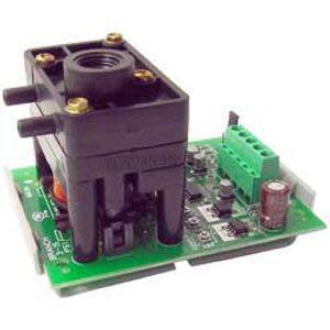 Open circuit board with a black rectangular sensor on top and a green screw terminal block on the side.