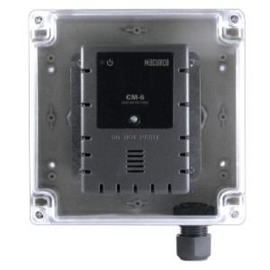 A rectangular gas detector with vents and a power indicator mounted inside a transparent plastic box with screws at each corner.