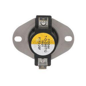 A compact circular temperature safety switch with a yellow center label and two electrical tabs, mounted on a flat silver bracket with two screw holes.