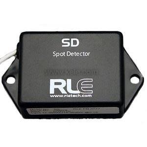 Small black box labeled “SD Spot Detector” with two flanges for mounting