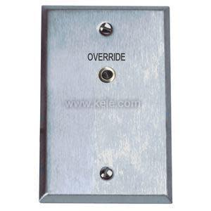 Rectangular brushed metal faceplate with the word 'Override' printed above a small round recessed button; two screws secure it top and bottom.