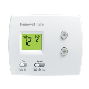 White digital thermostat with small screen reading 72 degrees and up-down buttons for temperature adjustment.